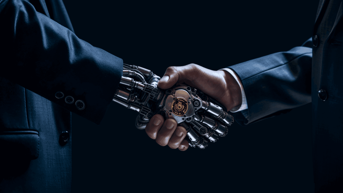man and robot shaking hands