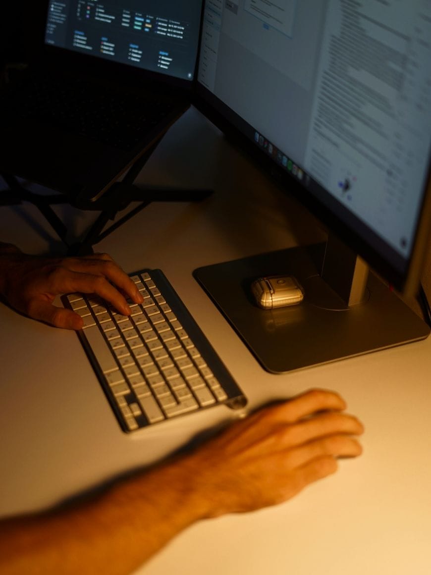 hands on the keyboard and the computer monitor