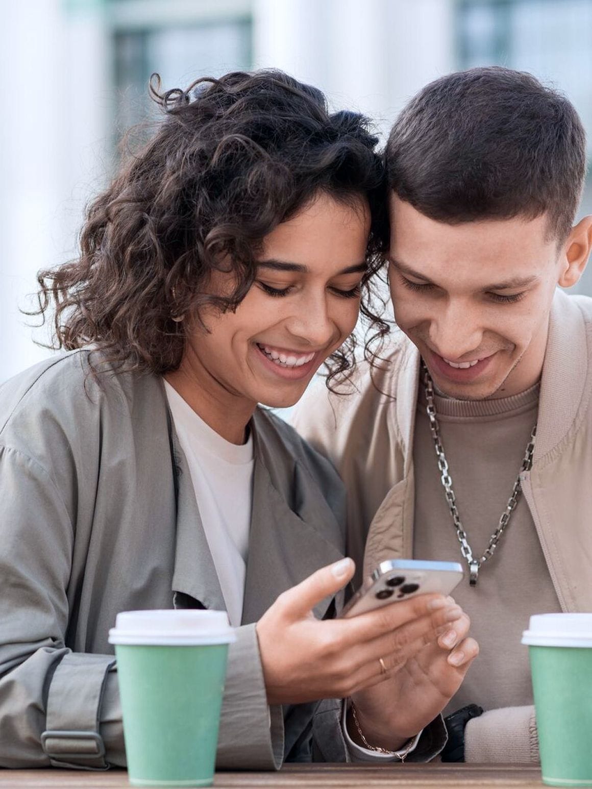 man and woman looking at the phone screen